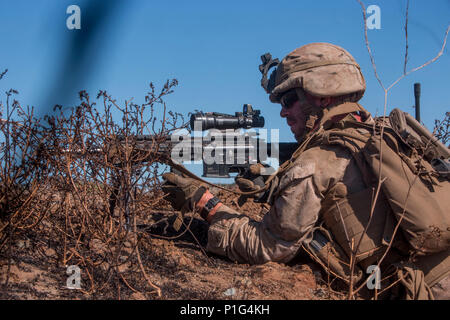 Lance Cpl. Seth Trunick, a scout rifleman with 1st Light Armored Reconnaissance Battalion, 1st Marine Division, takes up a firing position during a field exercise aboard Marine Corps Base Camp Pendleton, Calif., Oct. 25, 2016. The exercise was held as part of a week-long Marine Corps Combat Readiness Evaluation to ensure combat readiness before deployments.  This training allows Marines to become proficient and comfortable with their weapon systems in a realistic environment. (U.S. Marine Corps photo illustrated by Cpl. Justin Huffty) Stock Photo