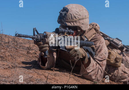 Pfc. Elmer Perez, a scout rifleman with 1st Light Armored Reconnaissance Battalion, 1st Marine Division, takes up a firing position during a field exercise aboard Marine Corps Base Camp Pendleton, Calif., Oct. 25, 2016.  The exercise was held as part of a week-long Marine Corps Combat Readiness Evaluation. Marines undergo MCCREs to ensure combat readiness before deployments. This training allows Marines to become proficient and comfortable with their weapon systems in a realistic environment. (U.S. Marine Corps photo by Cpl. Justin Huffty) Stock Photo