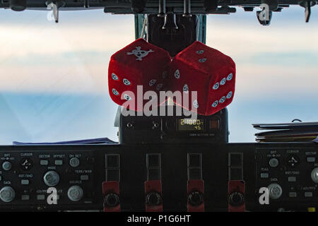 Fuzzy dice hang in the cockpit of a KC-135 Stratotanker assigned to the Utah Air National Guard’s 191st Air Refueling Squadron during a two-week training exercise on October 26, 2016. The squadron provided two refueling crews to support over 200 sorties flown by Aviano’s 555th and 510th Fighter Squadrons. The KC-135 extends range and endurance of fighter and transport aircraft while supporting mid-air refueling training, operational readiness, coordination, and multinational air operations. Stock Photo