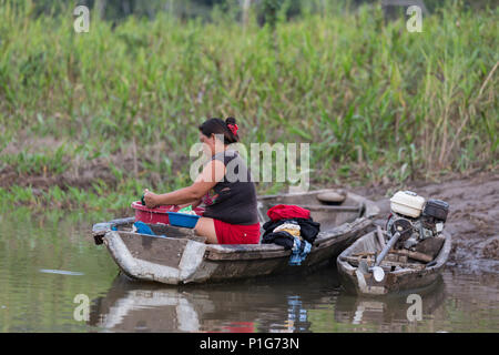 Woman cleaning laundry at Atun Pozas, Upper Amazon River Basin, Loreto, Peru Stock Photo