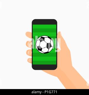 Hand holding smartphone displaying a black and white soccer ball on a green grass field Stock Vector