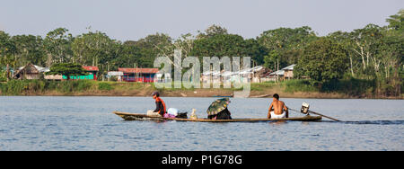 Family in dugout canoe with motor on Clavero Lake, Loreto, Peru Stock Photo