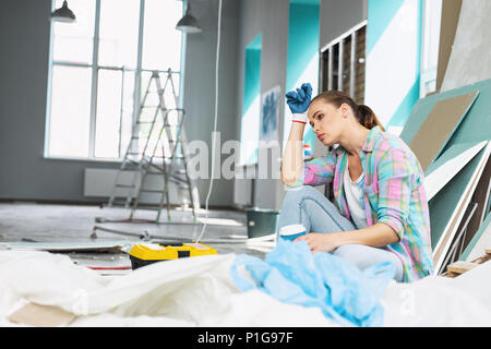 Dog-tired young woman having a break Stock Photo