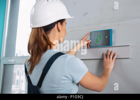 Female skilled builder working with her tools Stock Photo