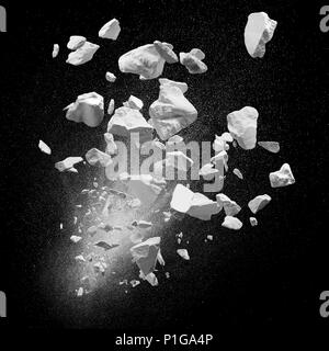 broken debris caused by explosion against black background Stock Photo