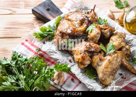 Fried chicken wings of barbecue on wooden table. Stock Photo