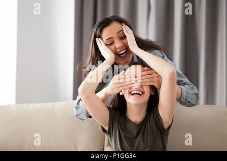 Two girlfriends are playing hide and seek Stock Photo