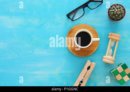 Mix of office supplies and gadgets on a blue wooden table background. top view Stock Photo