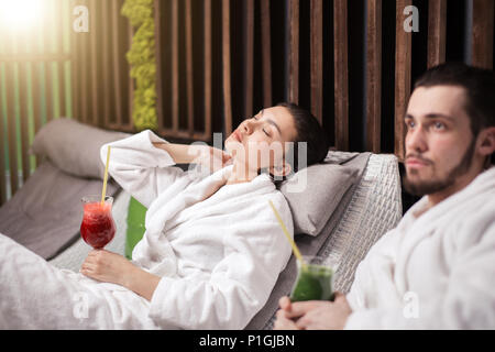 nice meditating woman and pensive pleasant guy in the spa resort Stock Photo