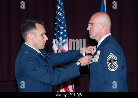 Maxwell AFB, Ala. -  Lieutenant Colonel Mark Holmes, Vice Commander, Thomas N. Barnes Center for Enlisted Education, presents the Legion of Merit to Chief Master Sergeant Charles E. Mills during the Air Force Senior NonCommissioned Officer Academy Assumption of Leadership, Oct 24, 2016. Mills assumed leadership of the AFSNCOA. (US Air Force photo by Bud Hancock/Released) Stock Photo