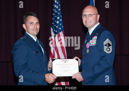 Maxwell AFB, Ala. -  Lieutenant Colonel Mark Holmes, Vice Commander, Thomas N. Barnes Center for Enlisted Education, presents the Legion of Merit to Chief Master Sergeant Charles E. Mills during the Air Force Senior NonCommissioned Officer Academy Assumption of Leadership, Oct 24, 2016. Mills assumed leadership of the AFSNCOA. (US Air Force photo by Bud Hancock/Released) Stock Photo