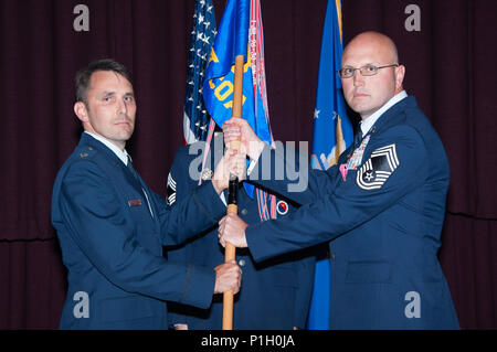 Maxwell AFB, Ala. -  Lieutenant Colonel Mark Holmes, Vice Commander, Thomas N. Barnes Center for Enlisted Education, presents the guidon of the Air Force Senior NonCommissioned Officer Academy to Chief Master Sergeant Charles E. Mills during the Assumption of Leadership, Oct 24, 2016. The guidon bearer for the ceremony was CMSgt Marc Schoellkopf. (US Air Force photo by Bud Hancock/Released) Stock Photo