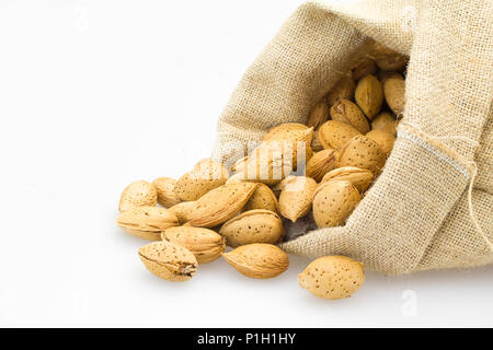 organic almonds inside a rustic bag Stock Photo