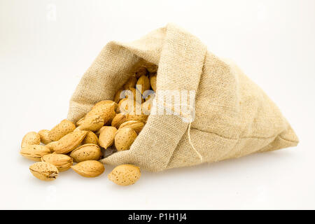 organic almonds inside a rustic bag Stock Photo