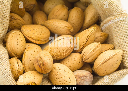 organic almonds inside a rustic bag Stock Photo