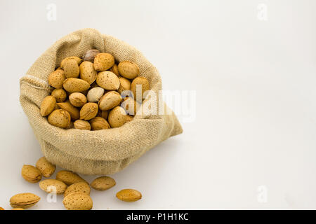 organic almonds inside a rustic bag Stock Photo