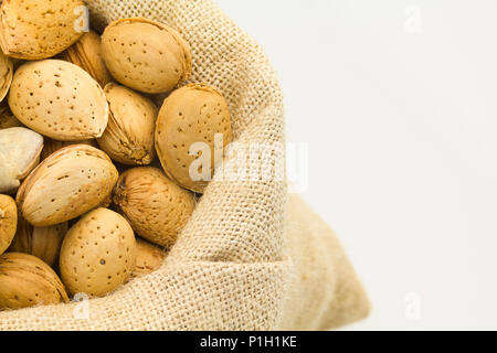 organic almonds inside a rustic bag Stock Photo