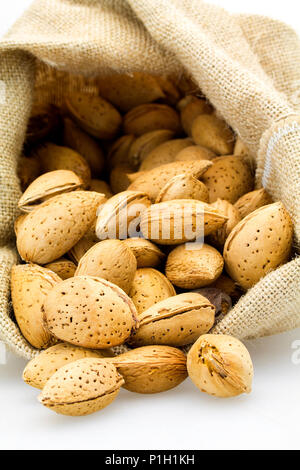 organic almonds inside a rustic bag Stock Photo