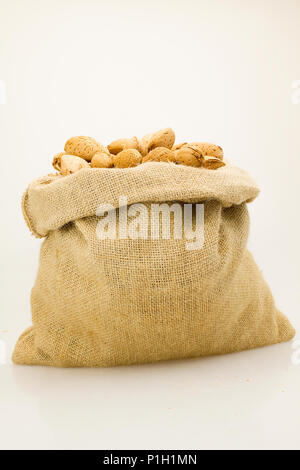 organic almonds inside a rustic bag Stock Photo