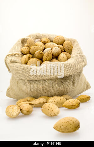 organic almonds inside a rustic bag Stock Photo