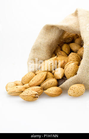 organic almonds inside a rustic bag Stock Photo