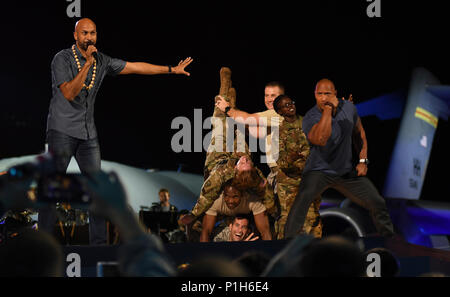 161022-N-GI544-276 PEARL HARBOR (Oct. 22, 2016) Keegan-Michael Key, left, and Dwayne “The Rock” Johnson, right, perform improvisation comedy with service members during the filming of “Rock the Troops” at Joint Base Pearl Harbor-Hickam.  Hosted by The Rock, “Rock the Troops” provided free music and entertainment to troops and their families. (U.S. Navy photo by Petty Officer 2nd Class Laurie Dexter/Released) Stock Photo