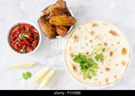 Homemade delicious food of tortillas, salsa and fried wings. Selective focus. Stock Photo