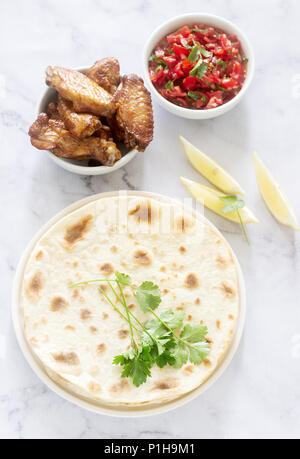 Homemade delicious food of tortillas, salsa and fried wings. Selective focus. Stock Photo