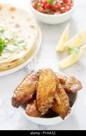 Homemade delicious food of tortillas, salsa and fried wings. Selective focus. Stock Photo