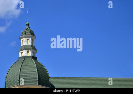 Completed perfect high-quality roofing work from metal roofing. The dome of a polyhedral shape with a spire is covered with green metal tiles Stock Photo