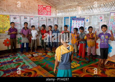 Rohingya refugee children attend class at a temporary school in ...