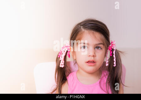 Portrait view of cute girl with confused expression on her face.isolated portrait. Stock Photo