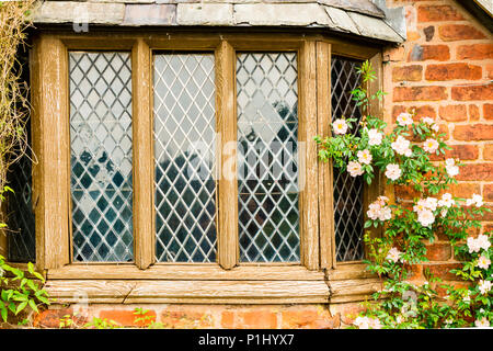 Old weathered leaded window of a garden house. Stock Photo
