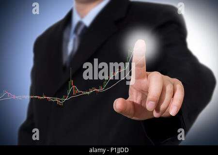 Businessman Touching a Graph Indicating Growth. Stock Photo