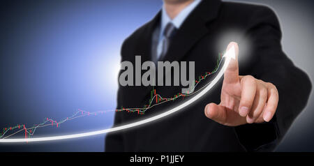 Businessman Touching a Graph Indicating Growth. Stock Photo