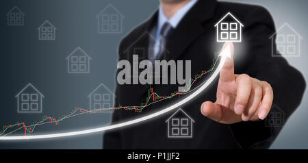 Businessman Touching a Graph Indicating Growth. Stock Photo