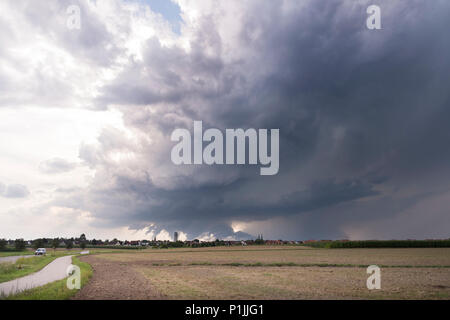 Storm split of two supercells, two wall clouds visible in the fore- and background, near Heilsbronn, Bavaria, Germany Stock Photo