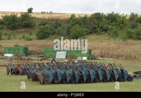 A lot of wheel barrows arranged in a field Stock Photo