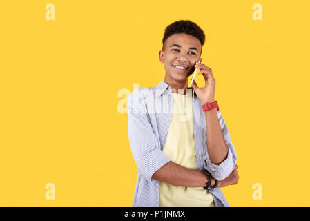 Positive nice man putting a phone to his ear Stock Photo