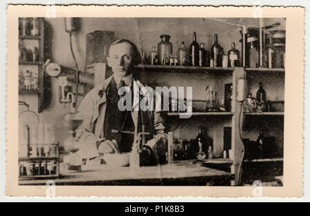 THE CZECHOSLOVAK REPUBLIC - CIRCA 1940s: Vintage photo shows man in the chemistry laboratory.  Black & white antique photography. Stock Photo