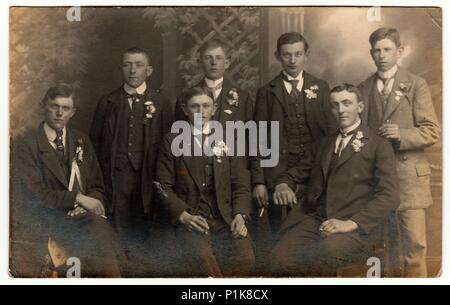 EILENBURG, GERMANY - CIRCA 1930s: Vintage photo shows young men (recruiters) pose at the photography studio. Black & white antique photography. Stock Photo