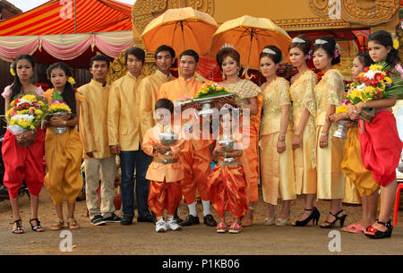 Wearing beautiful traditional Khmer wedding clothes the bride and groom with their attendants, pause for a photograph prior to the marriage ceremony. Stock Photo