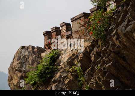 A crenelated wall jutting out of the rock face at Castillo Hidalgo on Santa Lucia Hill in Santiago, Chile.