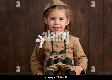 child girl are dressed as soldier in retro military uniforms Stock Photo