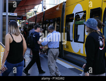 People boarding and deboarding at Cavill Avenue station of Glink Tram or Gold Coast Light Rail, Gold Coast Australia Stock Photo