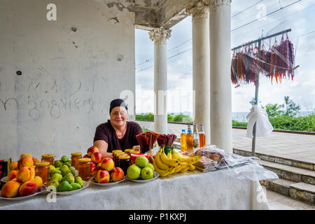 Batumi, Georgia - August 27, 2017: Lady selling churchkhela, fruits and other georgian delights at the train station. Stock Photo