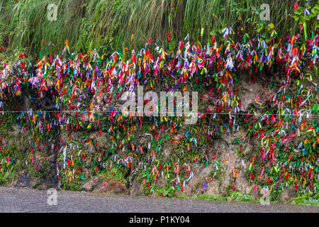 Colorful ribbons for wishes fulfillment on the side of the road in Abkhazia Stock Photo