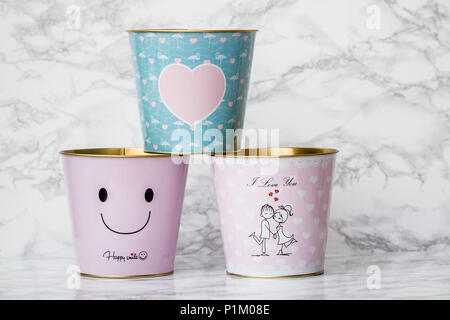 Decorative metallic popcorn boxes on white marble Stock Photo