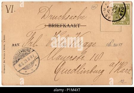 AMSTERDAM, THE NETHERLANDS - MAY 16, 1903: Back of a vintage photo - used postcard. Rich stain and paper details. Can be used as background. Image contains handwriting. Stock Photo