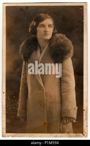 THE CZECHOSLOVAK REPUBLIC - CIRCA 1940s: Vintage photo shows an elegant woman wears light coat with fur collar. Black & white antique photography. Stock Photo